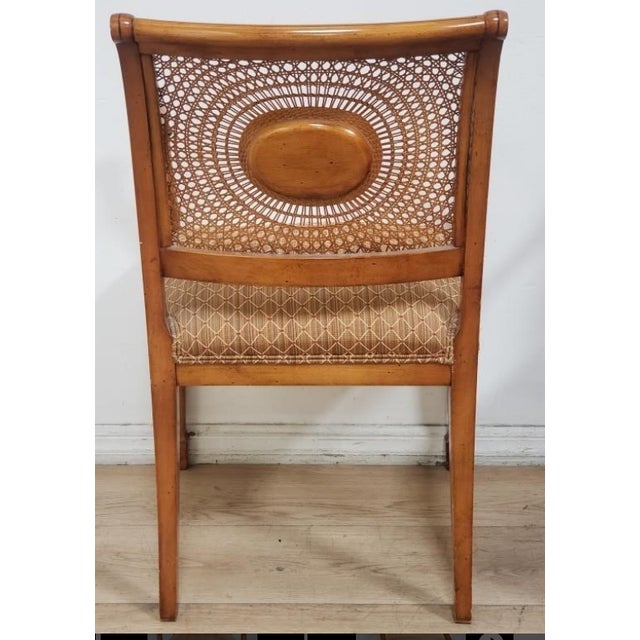 This elegant pair of Regency-style armchairs offers a timeless, neoclassical silhouette. Each chair features a beautifully...