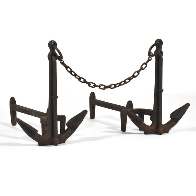 Striking pair of American cast-iron anchor andirons connected by anchoring chain. Original log stops and dog legs. The...