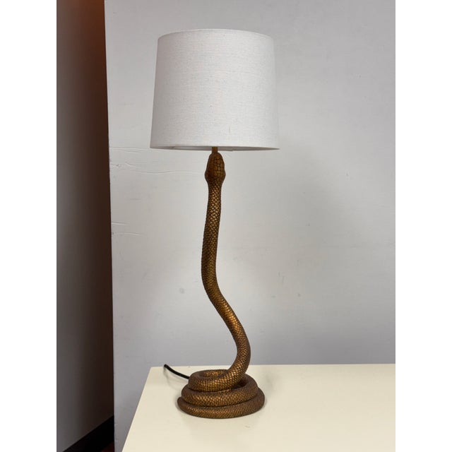 Design Plus Gallery presents the Snake Bronze Table Lamp by Brett Beldock for CB2. The sculptural base depicts a coiled...