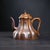 This exceptional Yixing Zisha teapot is handcrafted from high temp fired Duanni clay, prized for its warm sandy tone, fine...