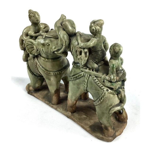 Celedon ceramic or clay sculpture of 2 elephants and 4 riders. One rider is missing his head from decades ago. No repairs...