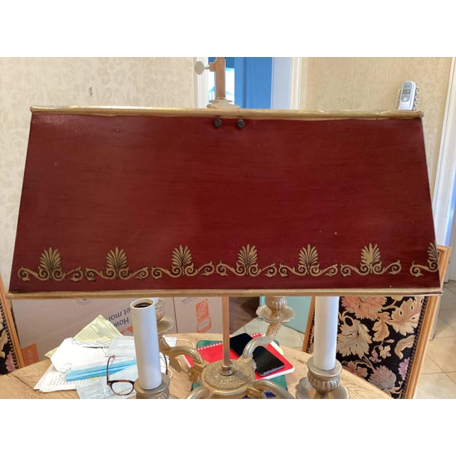 Very classic French Tole table lamp. Make of gilt brass with a painted metal shade, this is a stunning example of French...