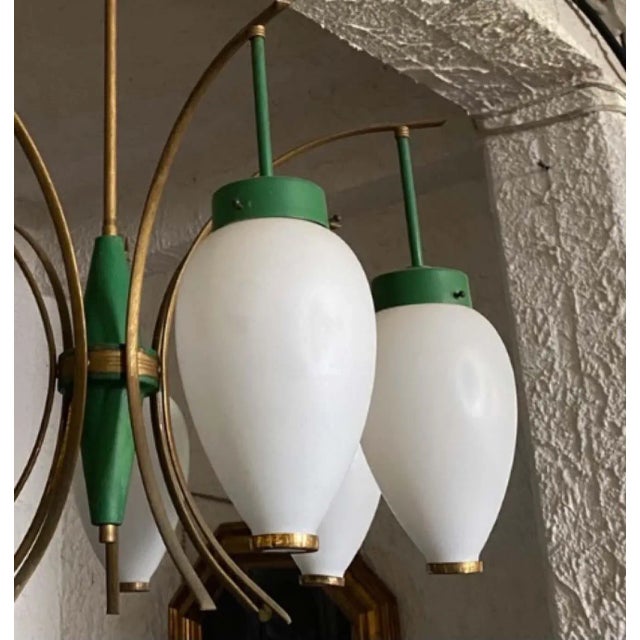 A six lights chandelier manufactured by Stilnovo in the Sixties, brass it's in original patina, green painted metal is in...