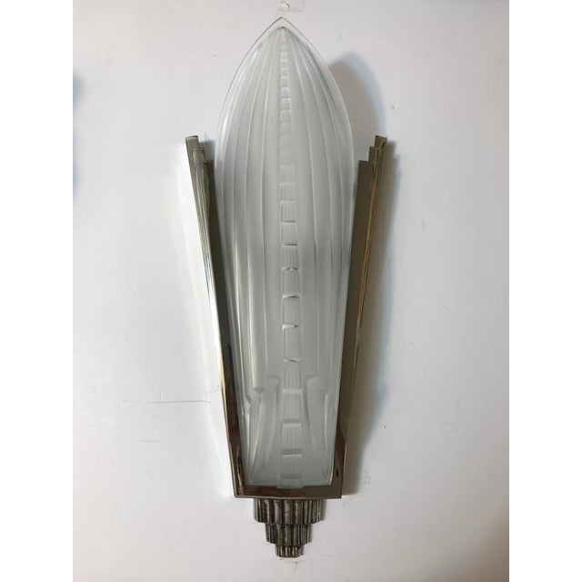 Beautiful pair of French Art Deco sconces signed by Gênet et Michon, "GM". Having clear and frosted glass slip shades with...