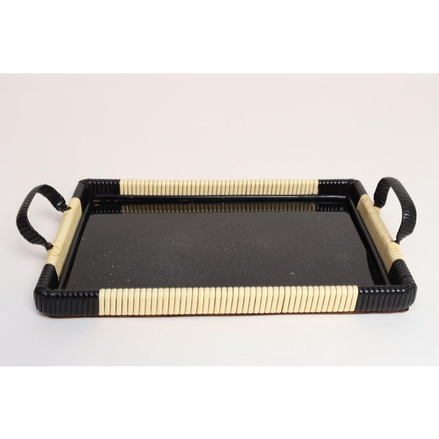Art Deco tray with cream and black raffia-esque rubber webbing with inset glass over a painted black wooden surface...