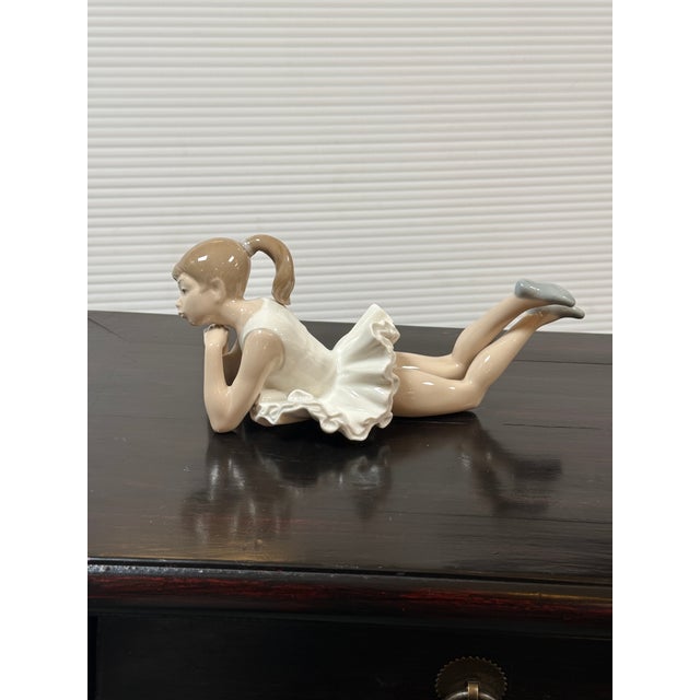 Design Plus Gallery presents the Porcelain Figurine Pensive Ballet by NAO for Lladró. The piece is crafted from premium...
