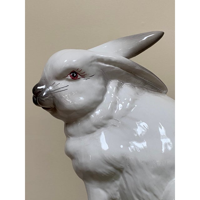 Handcrafted Italian ceramic rabbit sculpture featuring a naturalistic seated pose and hand-painted details. This...