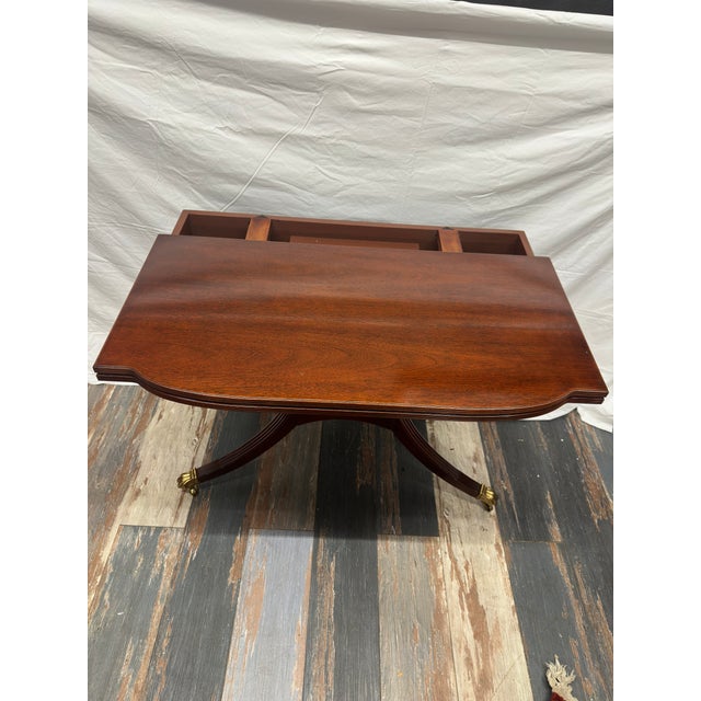 An absolute masterwork of luxury American cabinetry, this vintage mahogany drop-leaf pedestal table was bench-made by...