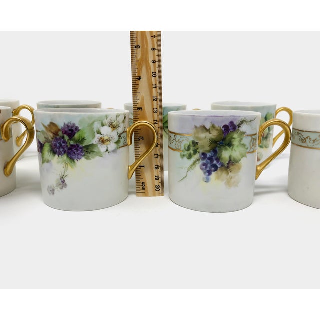 This set of 8 artist signed hand painted porcelain mugs with gold gilding are all in good condition as pictured with no...