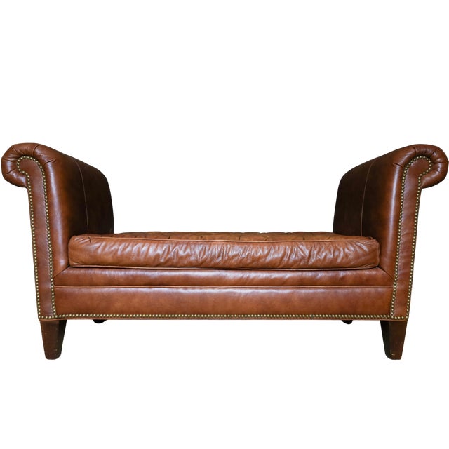 Bring timeless British sophistication and warmth into your space with this exquisite Chesterfield-style leather bench....