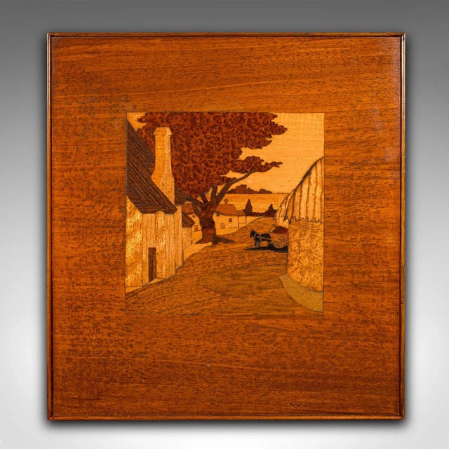 This is an antique landscape panel. An English, mahogany, oak and burr walnut marquetry farmyard scene, dating to the...