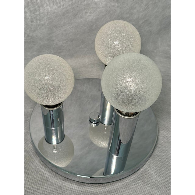 Striking vintage ceiling lamp with three decorative textured-glass bulbs mounted on a round chrome-plated base. Its...