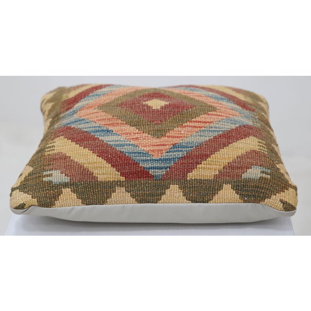 A one-of-a-kind handwoven Afghan wool kilim accent pillow featuring concentric diamond medallion. Cut and sewn by hand...