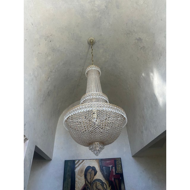 An impressive authentic Schonbek Camelot 2638 crystal chandelier, featuring the collection’s dramatic Empire-inspired...