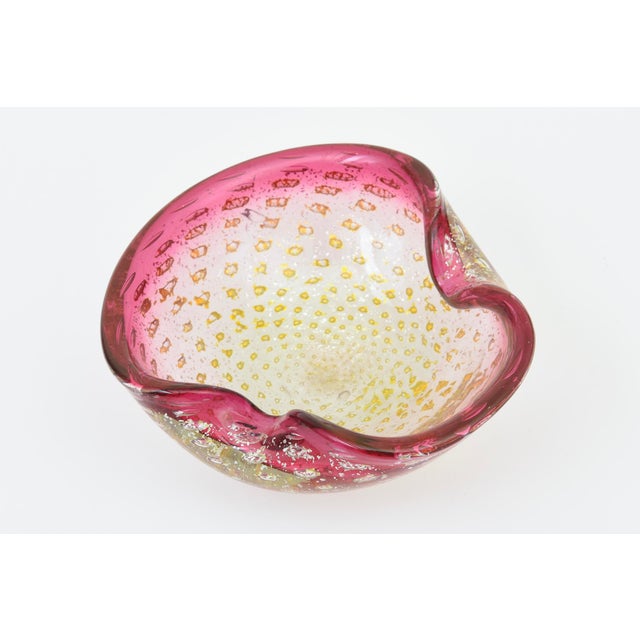 This vintage Italian 1960's Murano glass bowl has pinched sides. The top portion is pink with silver foil and gold foil...