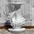 Elegant vintage coastal pedestal featuring a beautifully crafted conch shell design. A standout piece that brings seaside...