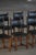 Elegant set of eight dining chairs crafted in oak wood with black leather upholstery. The design reflects the Swedish...