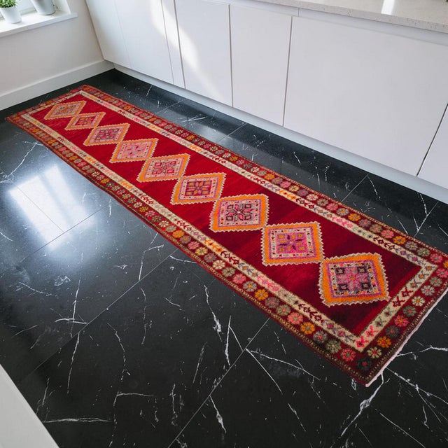 Hand-knotted by village artisans in the Oushak region of Aegean Anatolia during the 1960s, this vibrant runner rug is a...