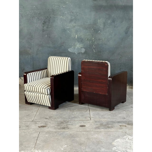 Pair of period French art deco club chairs upholstered in grey and white striped silk. Dark mahogany frames including...