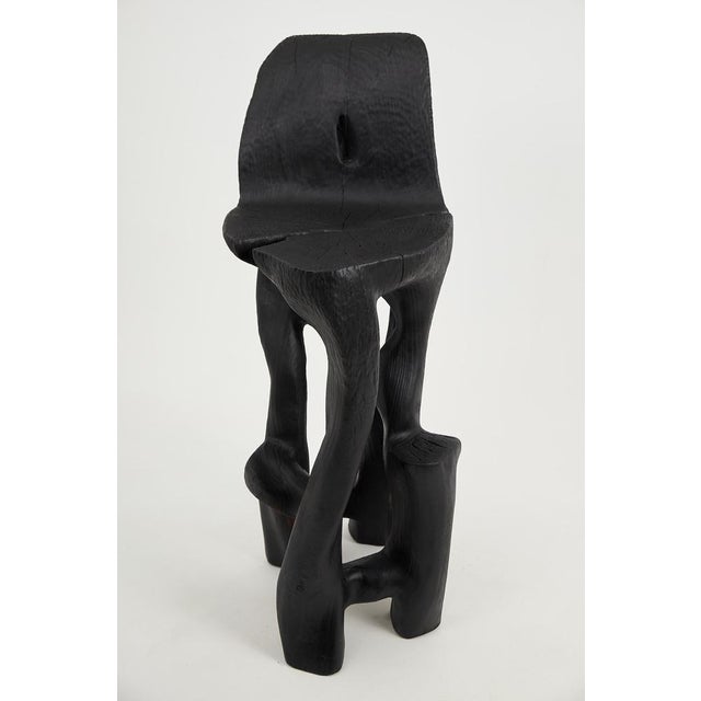 Unique chainsaw carved wooden functional sculpture usable as a bar chair. Carved from a single piece of wood and protected...