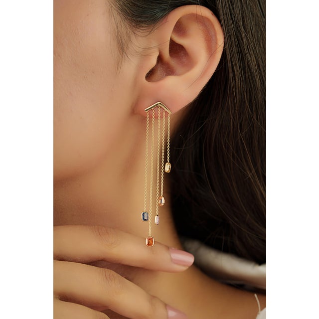 These elegant long drop earrings showcase 2.43 carats of multi sapphires set in 14K yellow gold. The gemstones measure...