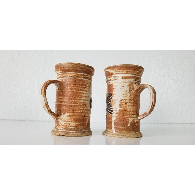 This is a stunning vintage artistic handmade and painted Fish motif decorative pottery mugs with mixed Crude and glaze...