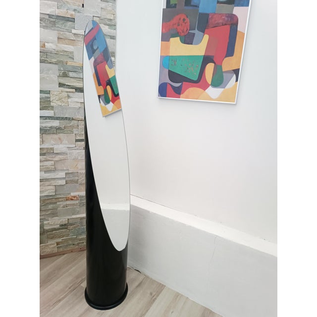 Magnificent Lipstick design floor mirror 1970s. Stable cylindrical wooden frame. It supports a beautiful oval mirror,...