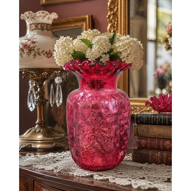 A beautiful vintage Fenton Art Glass vase crafted in rich cranberry glass and featuring the highly collectible Coin Dot...