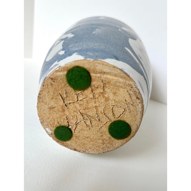 This signed sculptural studio pottery vase stands tall with a graceful, narrow neck and a beautifully expressive glaze....