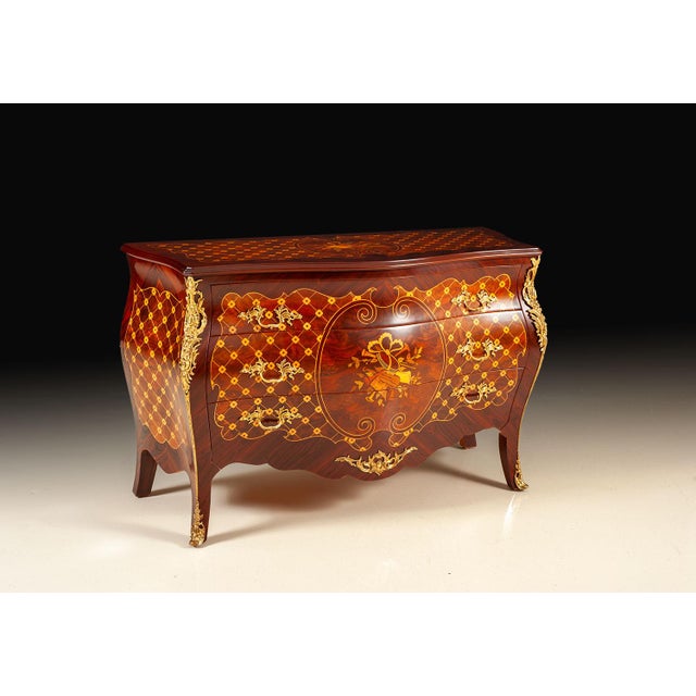 Handcrafted in Italy, this Bombay sideboard features a gracefully curved silhouette finished in richly figured walnut...