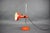 Vintage adjustable desk lamp produced in Germany during the 1970s. The lamp features a vibrant orange lacquered metal...