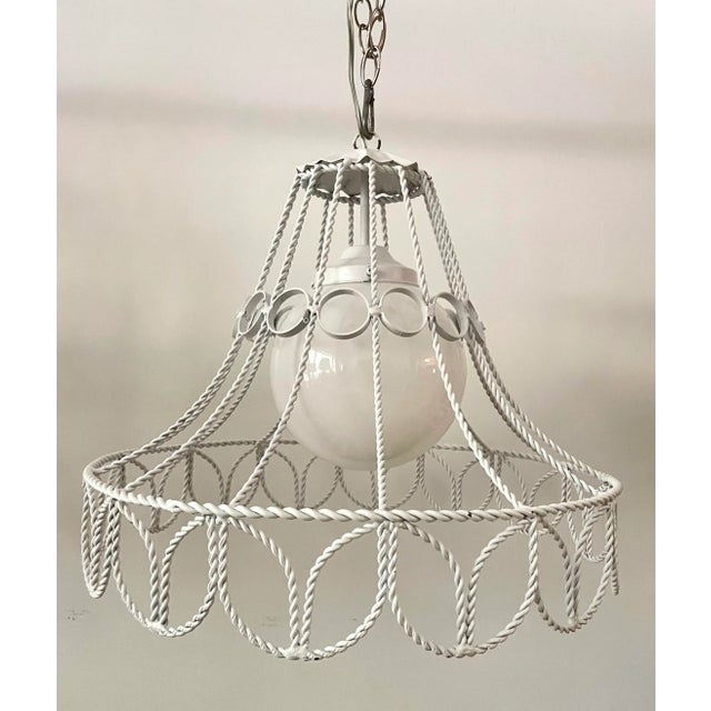 Here is a charming pendant, hardwire light fixture from the early mid-century. The light features a shade made of metal...