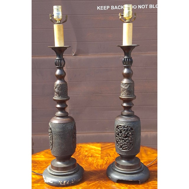 This pair of Japanese patinated bronze candle holders from the Meiji period (circa 1868 - 1912) feature intricate...