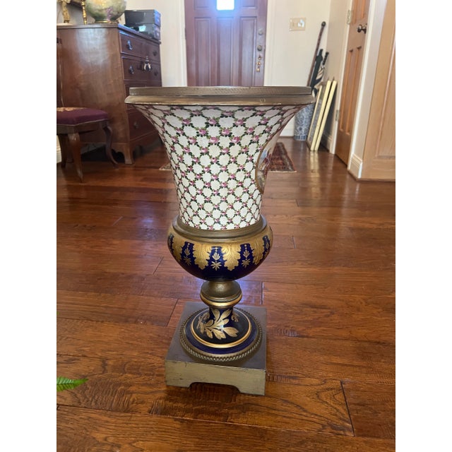 This beautiful, monumental urn is in the style of Sevres. It was purchased in an auction in Florida in the 1950’s. It is...