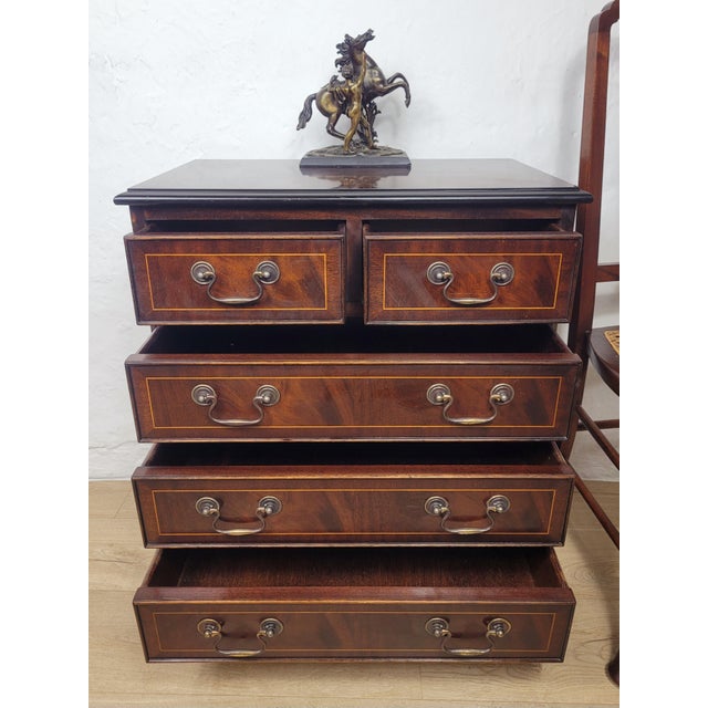 This is a gorgeous antique styled chest of drawers that is sure to excentuate the home setting. The chest displays a rich...