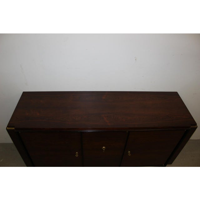Small Art Deco period sideboard in rosewood, it opens with three doors, original gilded bronze, similar to the production...