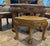 This is a finely crafted solid wood low table with four matching stools, featuring hand-carved narrative and decorative...
