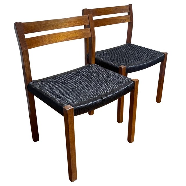 This pair of Model #401 dining chairs was designed by Arne Hovmand-Olsen for J.L. Møller. Representing a significant...