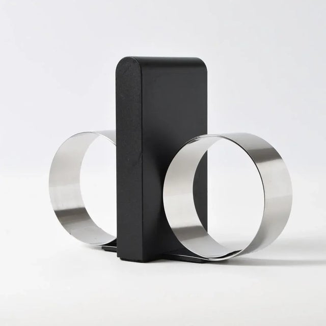 Bookend made of plastic with stainless steel springs on both sides. Designed in 1992 by Andreas Mikkelsen for Royal...