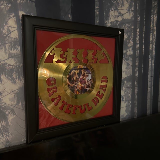 Elevate your music room with this stunning Grateful Dead Gold Vinyl display. This isn't just a record; it’s a piece of...
