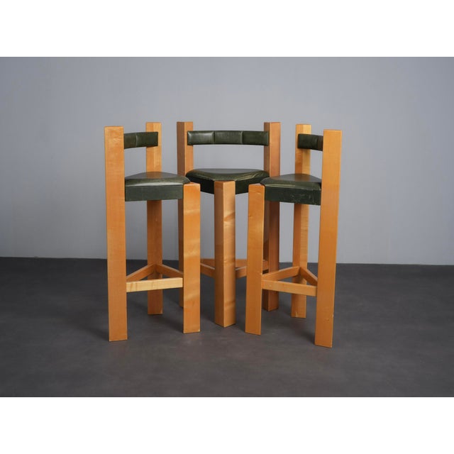 A distinctive set of three architectural bar stools from the 1990s, defined by strong vertical lines, bold proportions and...