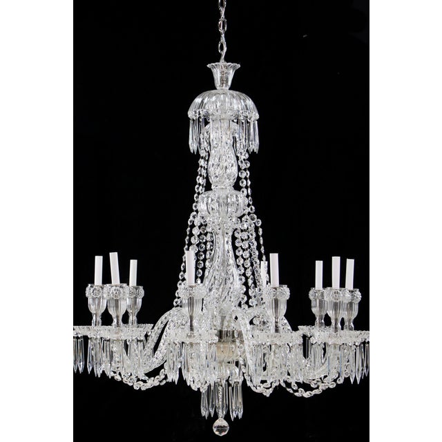 This mid-20th-century chandelier is designed in the Victorian style, featuring a tiered central column of cut glass. The...