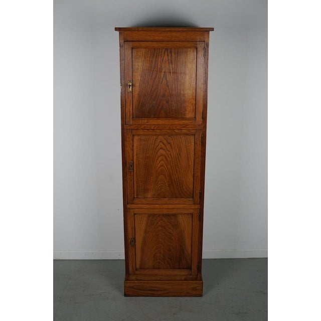 This Dutch oak locker / filing cabinet with 3 doors was made around the 1920/30s in the Netherlands. The interior...