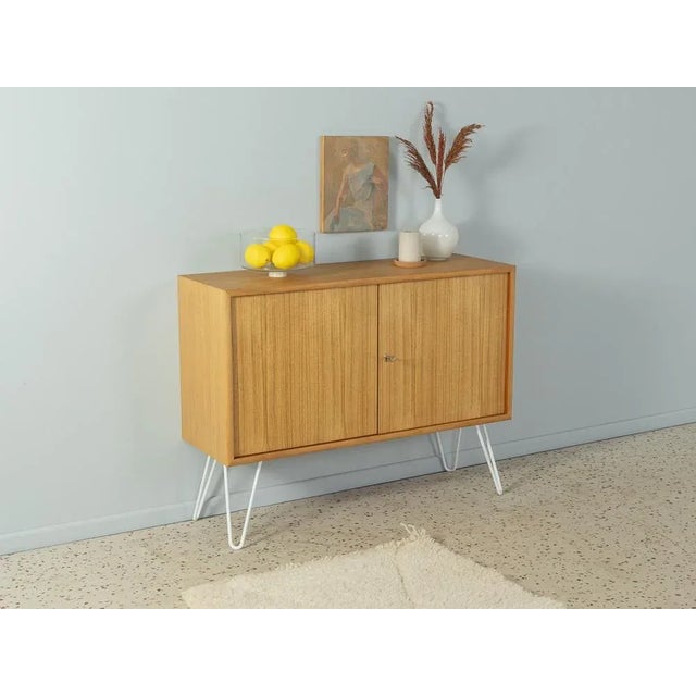 Wonderful chest of drawers from the 1960s. High-quality body in bleached teak veneer with two closet doors, a shelf and...