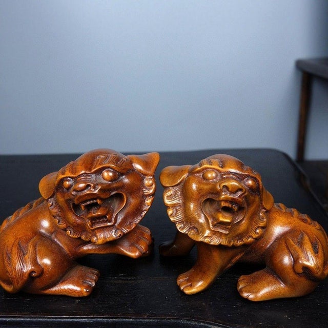 This charming pair of vintage boxwood carvings depicts guardian lions, or Foo Dogs, in a playful, recumbent posture. Each...