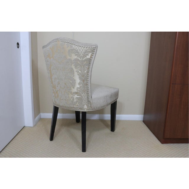 Add a touch of classic sophistication to your space with this beautifully upholstered accent chair. Featuring a gently...