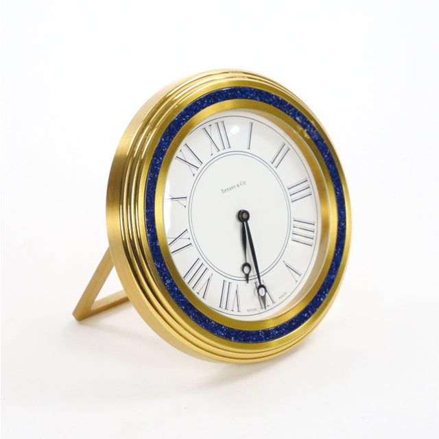 An elegant mid-20th-century desk clock by Tiffany & Co., dating to circa 1960, featuring a refined combination of gilt...