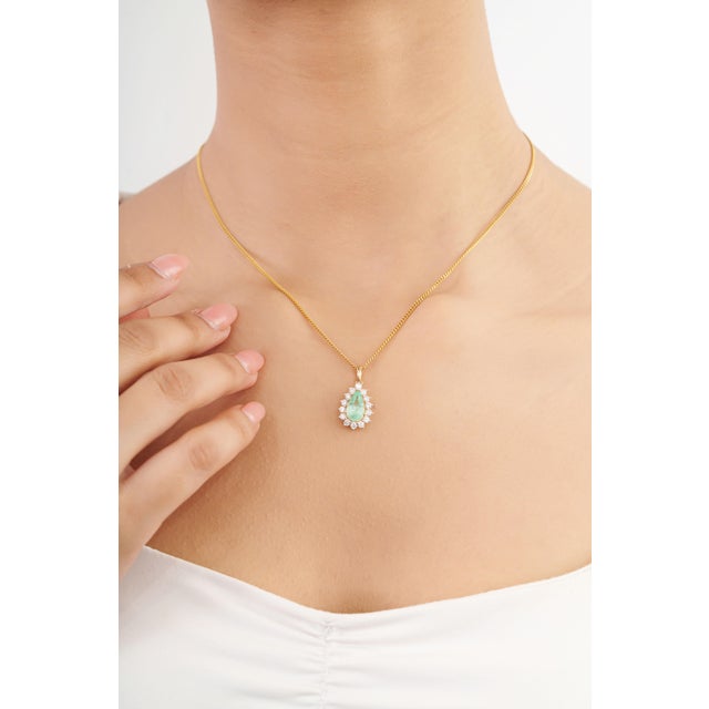 Elegant and timeless, this natural 1.15 carat Colombian emerald pendant showcases a beautiful green emerald surrounded by...