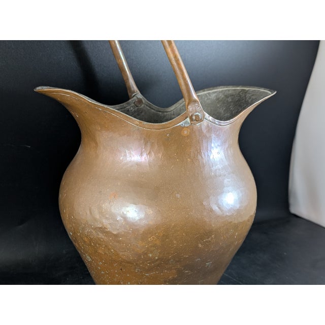 This pitcher is made of a mixture of galvanized steel with a copper exterior. The handle moves back and forth freely. It...