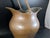 This pitcher is made of a mixture of galvanized steel with a copper exterior. The handle moves back and forth freely. It...